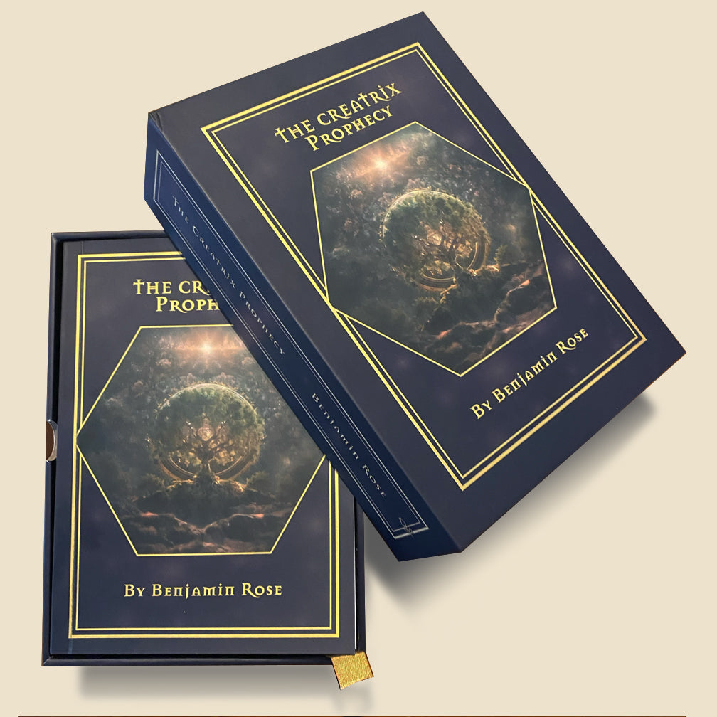 The actual navy-and-gold Creatrix Prophecy box and companion storybook, photographed on a cream background